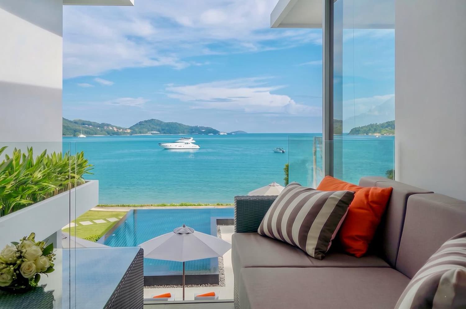 Terrace lounge seating with views over the pool and bay