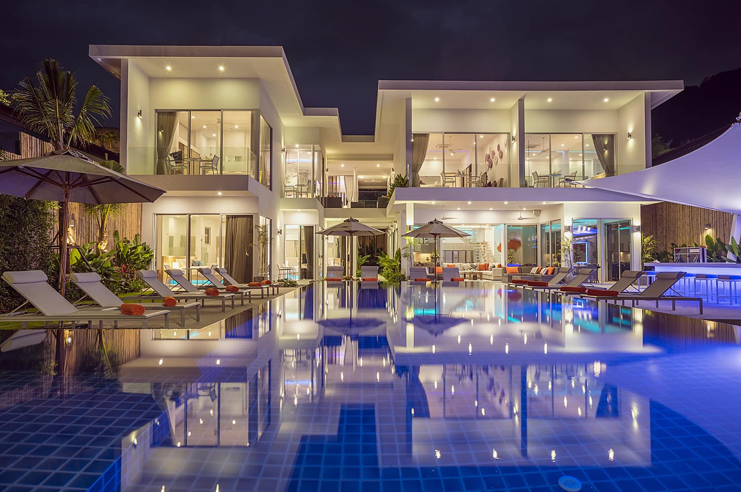 The villa and pool lit up at night